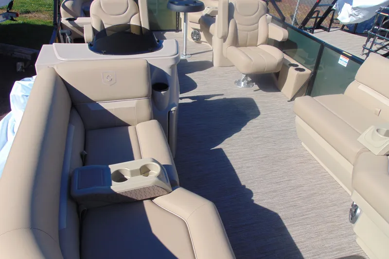 Slide: The Image of 2026 Godfrey Xperience 2086SBX pontoon boat interior with beige seating and cup holders. - 4