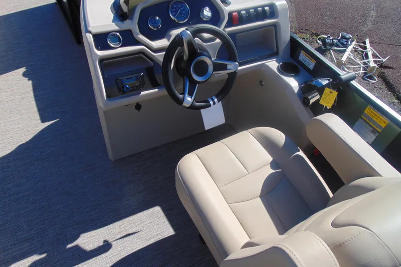 Slide: The Image of Interior of 2026 Godfrey Xperience 2086SBX boat with steering wheel and beige seating. - 8