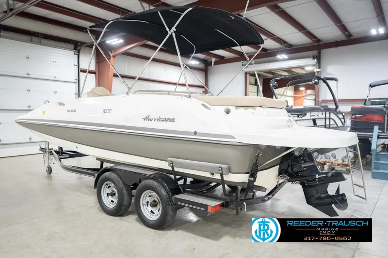 Slide: The Image of 2017 Hurricane SunDeck Sport 202 OB boat on trailer in indoor showroom. - 10