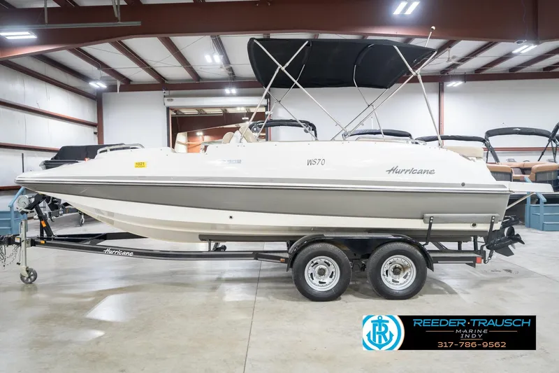 Slide: The Image of 2017 Hurricane SunDeck Sport 202 OB boat on trailer in indoor showroom. - 11
