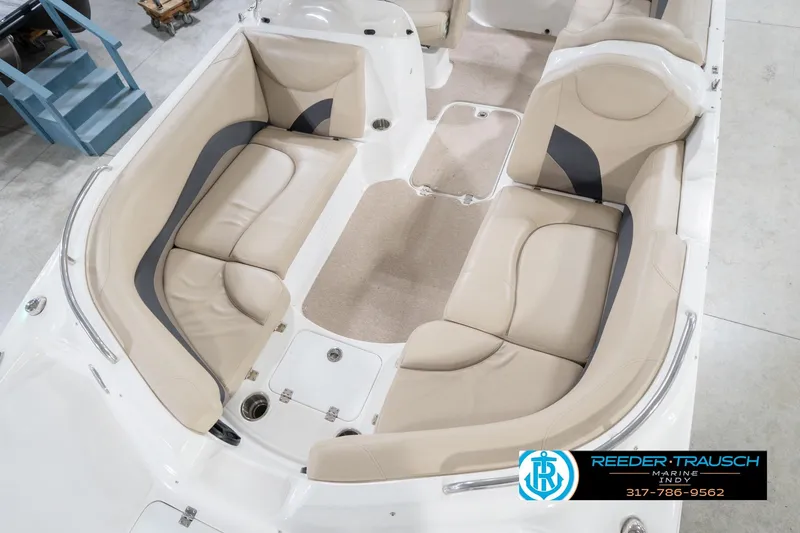 Slide: The Image of 2017 Hurricane SunDeck Sport 202 OB boat interior with beige seating and carpeted floor. - 12