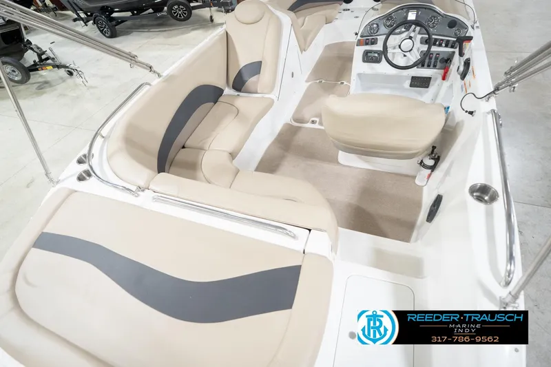 Slide: The Image of 2017 Hurricane SunDeck Sport 202 OB boat interior with beige seating and control panel. - 14