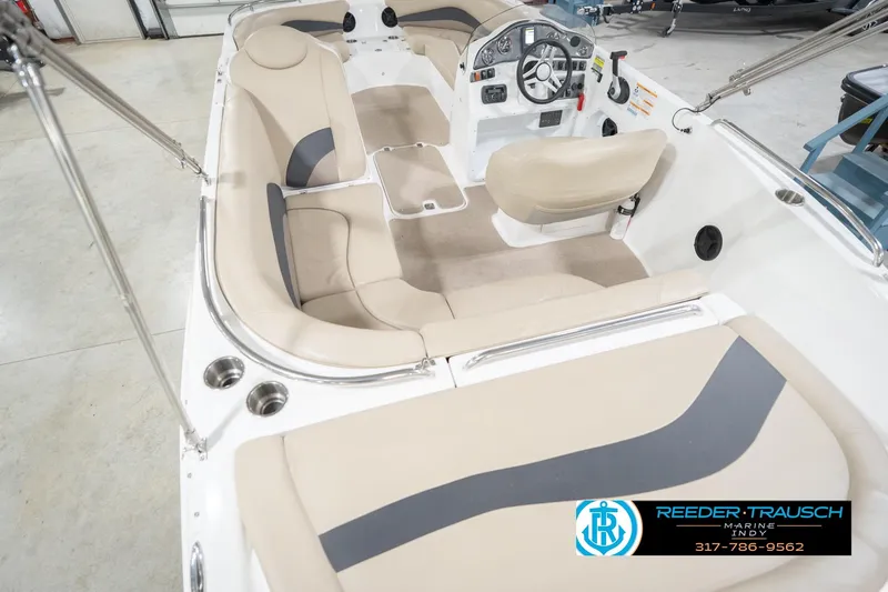 Slide: The Image of 2017 Hurricane SunDeck Sport 202 OB interior with beige seating and steering console. - 15