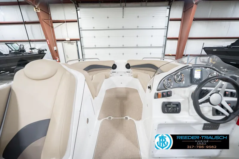 Slide: The Image of 2017 Hurricane SunDeck Sport 202 OB interior with beige seating and modern dashboard. - 17