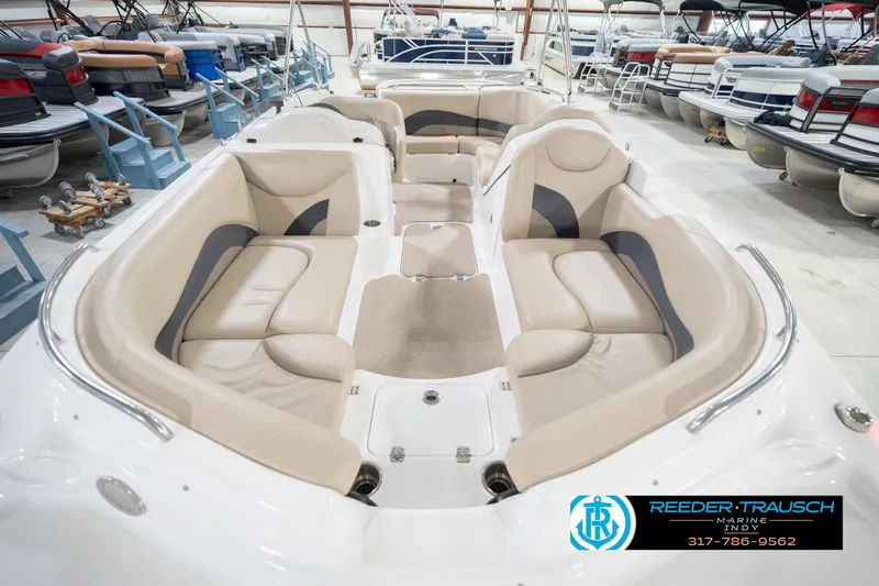 Slide: The Image of 2017 Hurricane SunDeck Sport 202 OB boat interior with beige seating in showroom. - 19