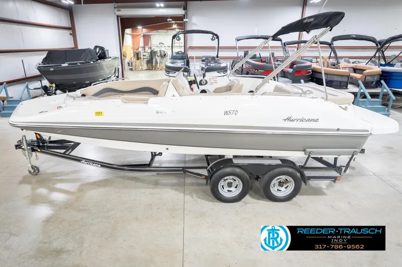 Slide: The Image of 2017 Hurricane SunDeck Sport 202 OB boat on trailer in showroom. - 2