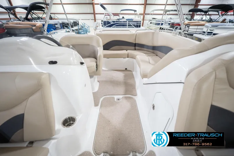 Slide: The Image of 2017 Hurricane SunDeck Sport 202 OB interior with beige seating in a showroom. - 20