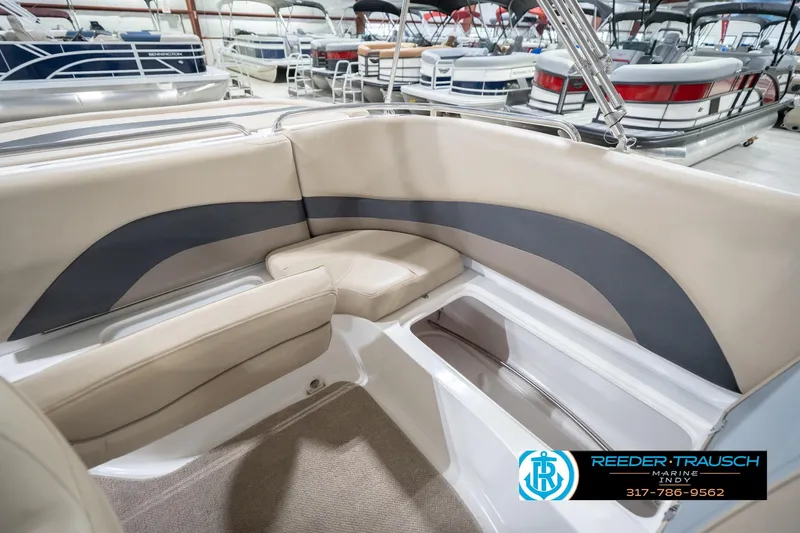 Slide: The Image of 2017 Hurricane SunDeck Sport 202 OB boat interior with beige seating and storage compartment. - 23