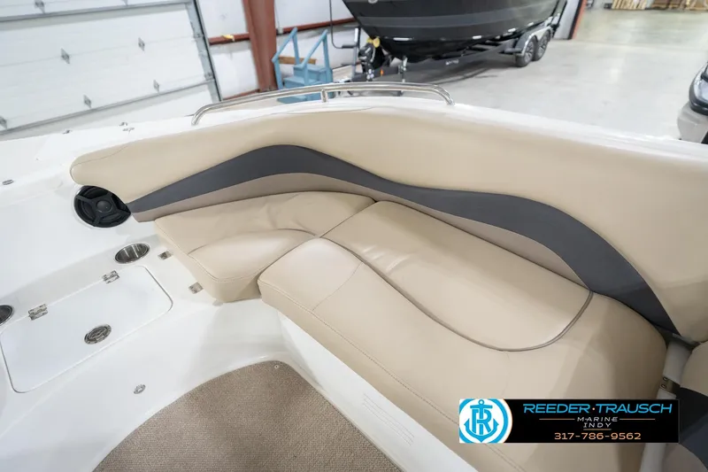 Slide: The Image of 2017 Hurricane SunDeck Sport 202 OB boat interior with beige seating and cup holders. - 24