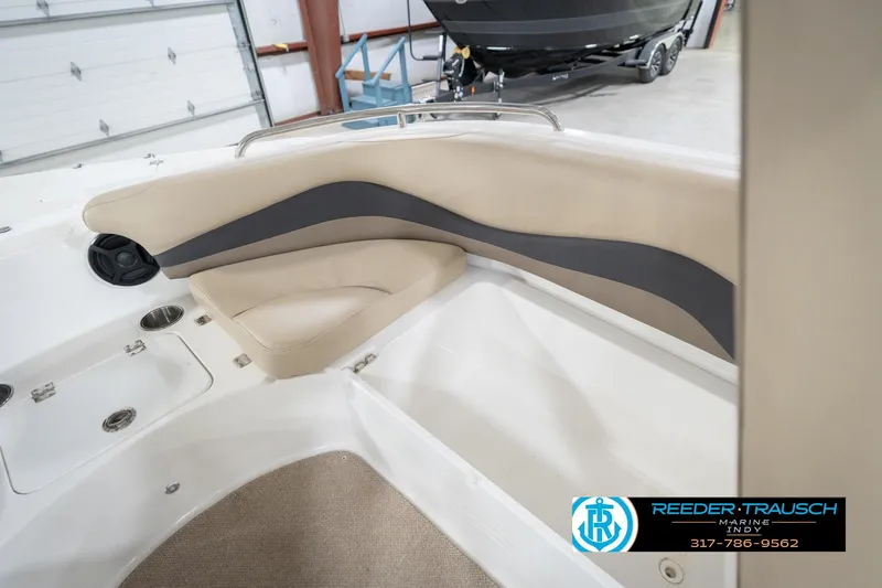 Slide: The Image of 2017 Hurricane SunDeck Sport 202 OB boat interior with beige seating and storage compartments. - 25