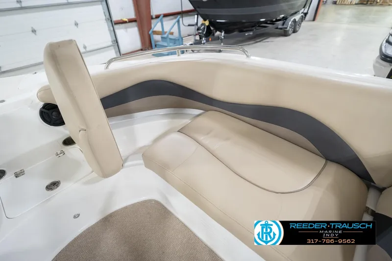 Slide: The Image of 2017 Hurricane SunDeck Sport 202 OB boat interior with beige seating in showroom. - 26