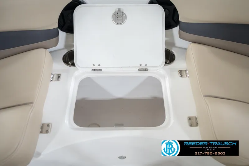 Slide: The Image of 2017 Hurricane SunDeck Sport 202 OB boat storage compartment with beige seating and cup holders. - 28