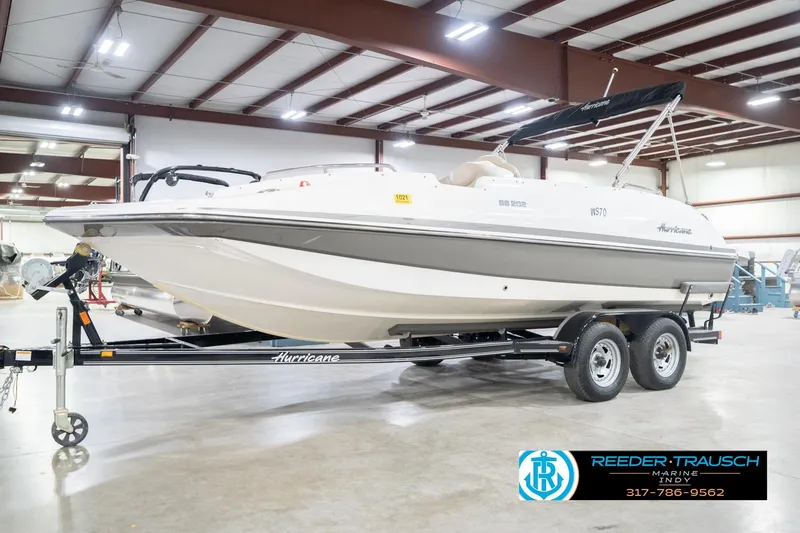 Slide: The Image of 2017 Hurricane SunDeck Sport 202 OB boat on trailer in indoor showroom. - 3