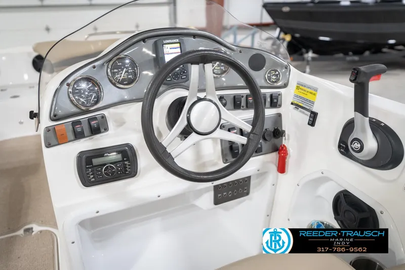 Slide: The Image of 2017 Hurricane SunDeck Sport 202 OB boat dashboard with steering wheel and controls. - 32