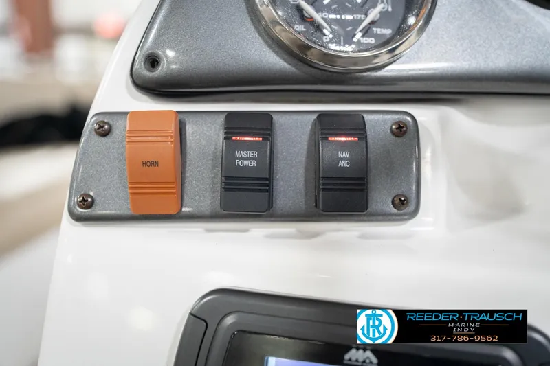 Slide: The Image of Control panel of a 2017 Hurricane SunDeck Sport 202 OB boat with switches and gauge. - 35
