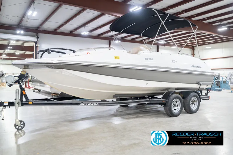 Slide: The Image of 2017 Hurricane SunDeck Sport 202 OB boat on trailer in indoor showroom. - 4
