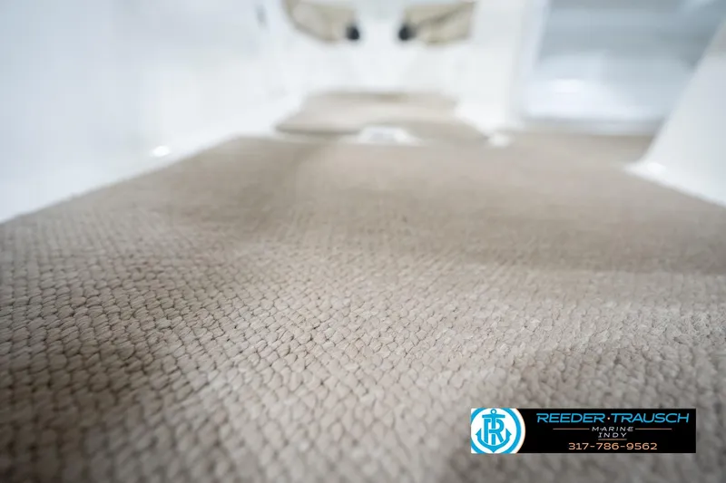 Slide: The Image of 2017 Hurricane SunDeck Sport 202 OB interior carpet detail, featuring beige textured flooring. - 49