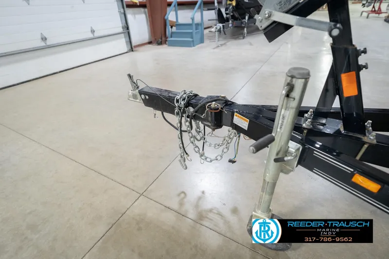 Slide: The Image of Trailer hitch of a 2017 Hurricane SunDeck Sport 202 OB in a garage setting. - 54