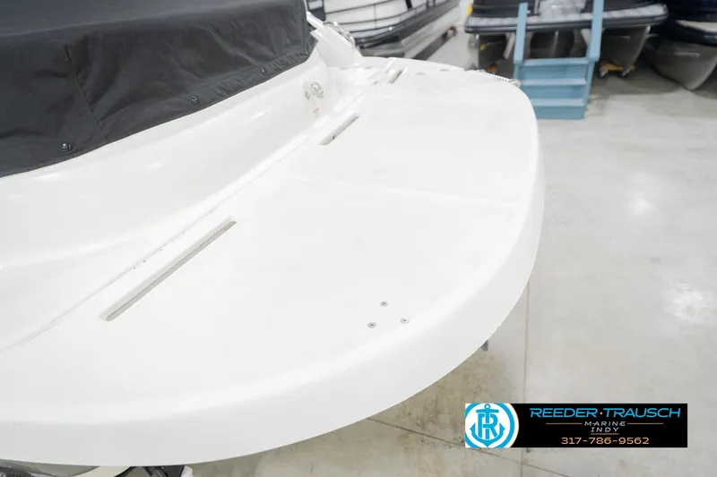 Slide: The Image of 2017 Hurricane SunDeck Sport 202 OB boat with covered seating area in showroom. - 58