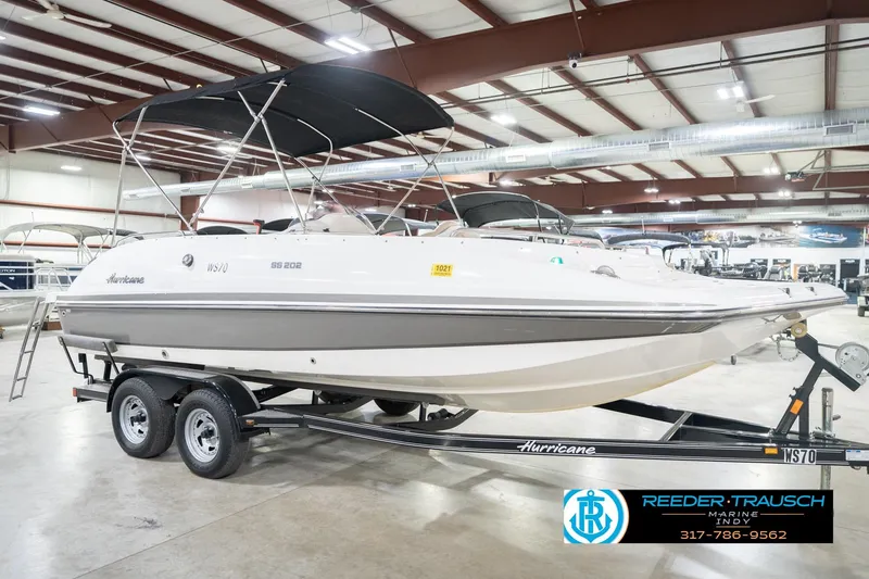 Slide: The Image of 2017 Hurricane SunDeck Sport 202 OB boat on trailer in indoor showroom. - 6
