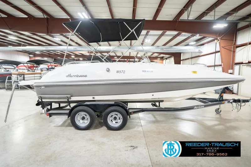 Slide: The Image of 2017 Hurricane SunDeck Sport 202 OB boat on trailer in indoor showroom. - 7
