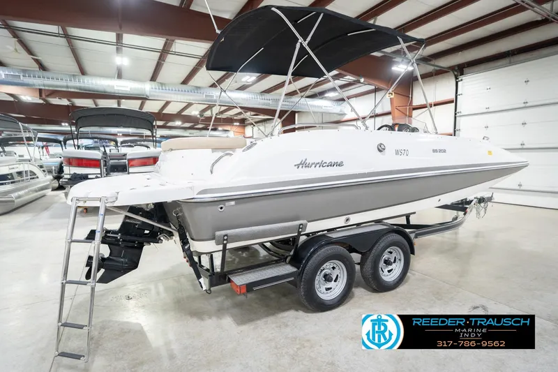 Slide: The Image of 2017 Hurricane SunDeck Sport 202 OB boat on trailer in indoor showroom. - 8