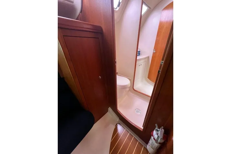 Slide: The Image of 2003 Hunter 386 yacht bathroom with wooden cabinetry and compact design. - 16