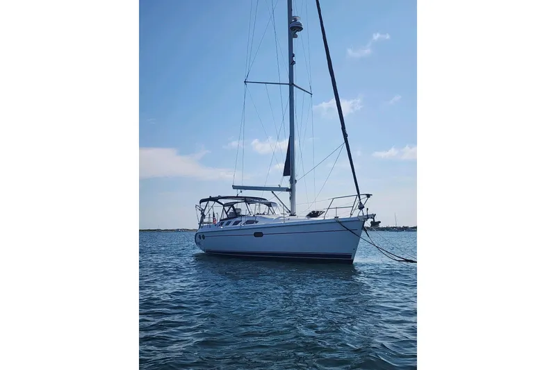 Slide: The Image of Sailboat on calm water, 2003 Hunter 386 model, under clear blue sky. - 2