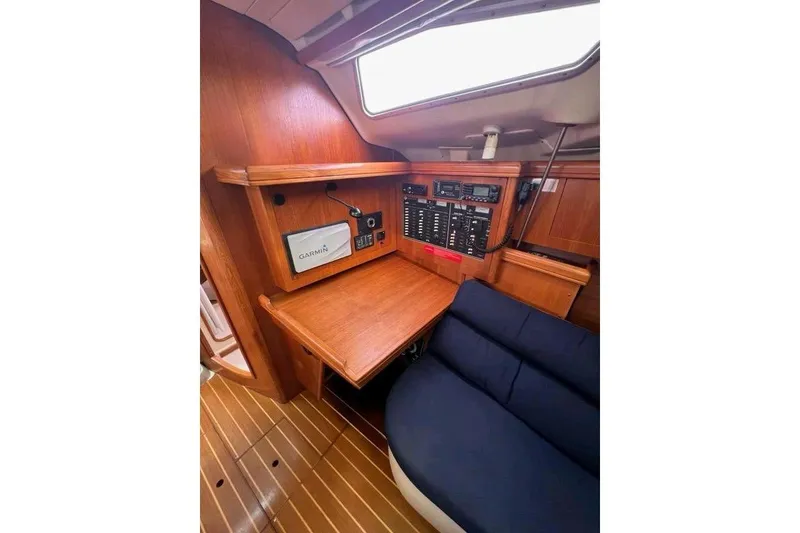 Slide: The Image of Interior of 2003 Hunter 386 sailboat with navigation equipment and wooden cabinetry. - 22