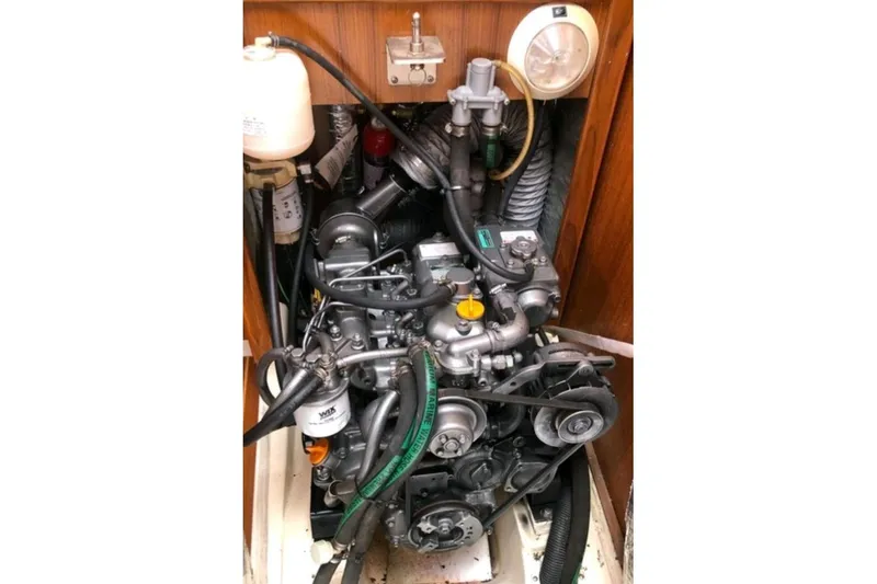 Slide: The Image of Engine compartment of a 2003 Hunter 386 sailboat, showcasing mechanical components. - 23