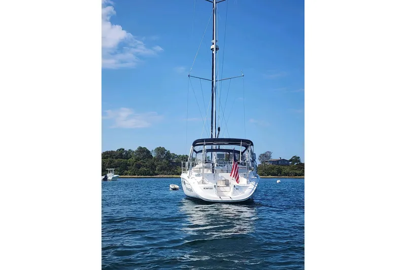Slide: The Image of Sailboat on water, 2003 Hunter 386, with American flag, clear sky background. - 7