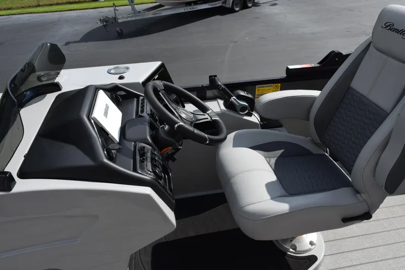 Slide: The Image of 2026 Bentley Pontoons Elite 223 Swingback helm with luxurious captain's chair and modern controls. - 10
