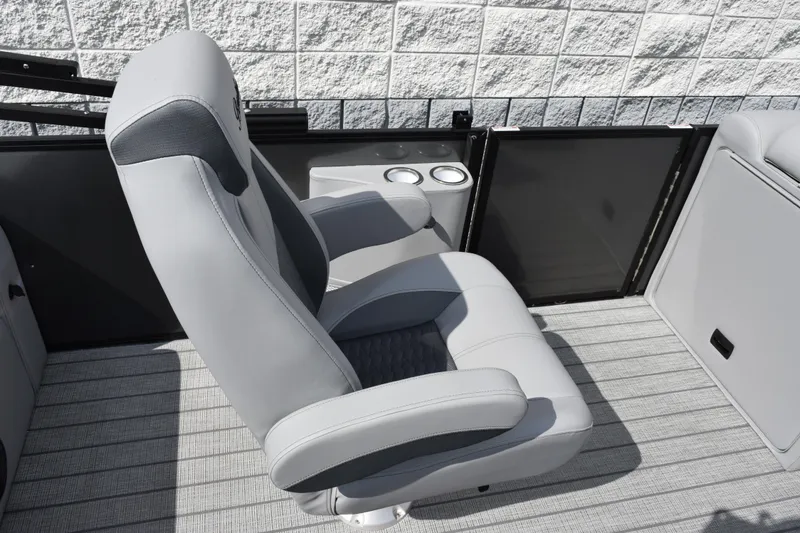 Slide: The Image of 2026 Bentley Pontoons Elite 223 Swingback interior with luxurious seating and cup holders. - 13