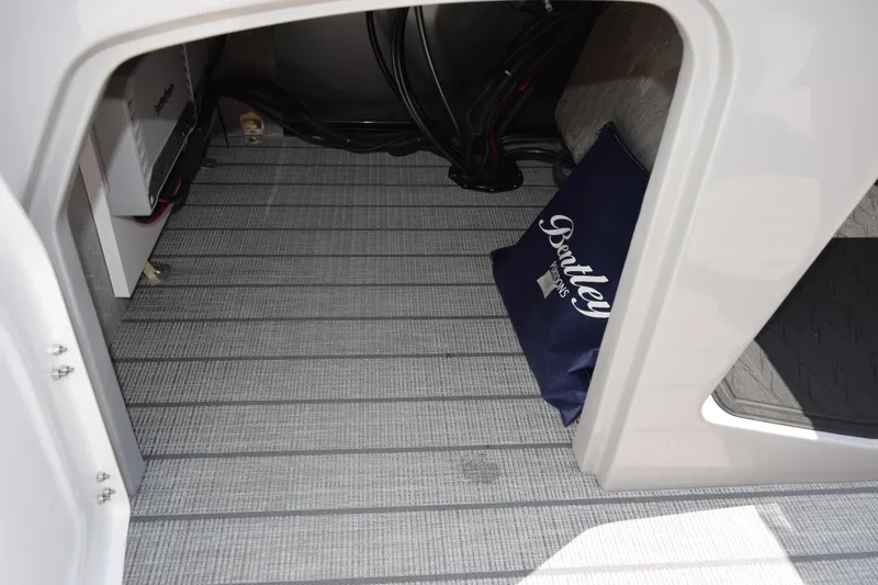Slide: The Image of Interior storage of 2026 Bentley Pontoons Elite 223 Swingback with branded cushion. - 18