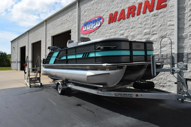 Slide: The Image of 2026 Bentley Pontoons Elite 223 Swingback on trailer outside marine dealership. - 2