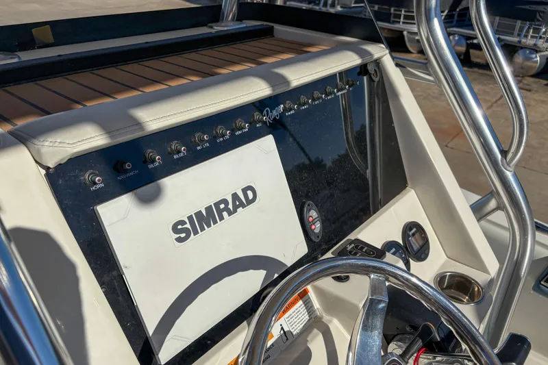 Slide: The Image of 2019 Ranger 2510 Bay boat dashboard with Simrad navigation system and control panel. - 10