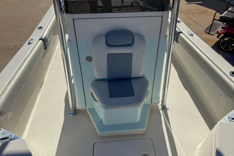 Slide: The Image of 2019 Ranger 2510 Bay boat interior with cushioned seating and console. - 12