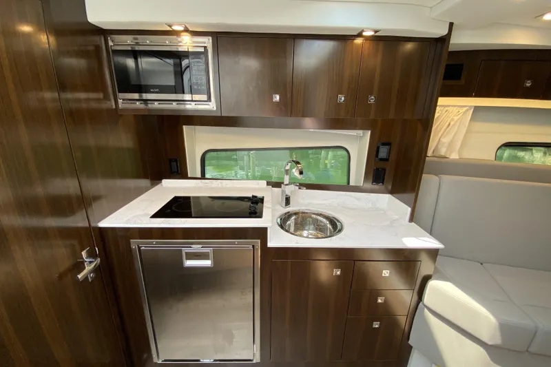 Slide: The Image of Luxurious 2021 Cruisers Yachts 390 Express Coupe kitchen with modern appliances and sleek design. - 10