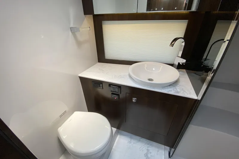 Slide: The Image of Luxurious bathroom in 2021 Cruisers Yachts 390 Express Coupe with modern fixtures and elegant design. - 12