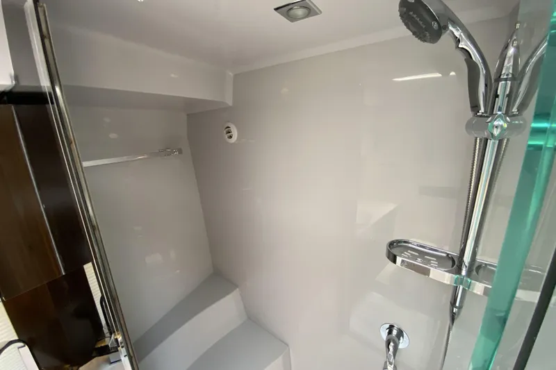 Slide: The Image of 2021 Cruisers Yachts 390 Express Coupe shower area with modern fixtures and sleek design. - 13