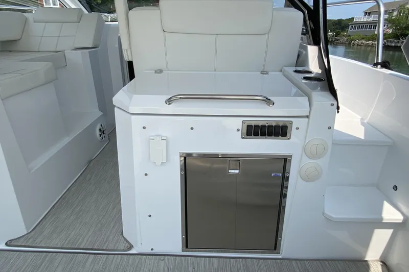 Slide: The Image of 2021 Cruisers Yachts 390 Express Coupe interior with sleek white seating and modern amenities. - 2