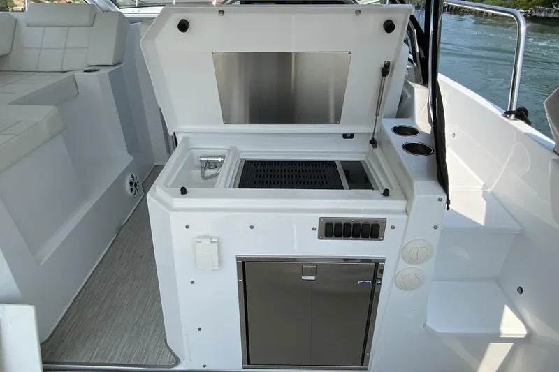 Slide: The Image of 2021 Cruisers Yachts 390 Express Coupe outdoor kitchen with grill and sink. - 3