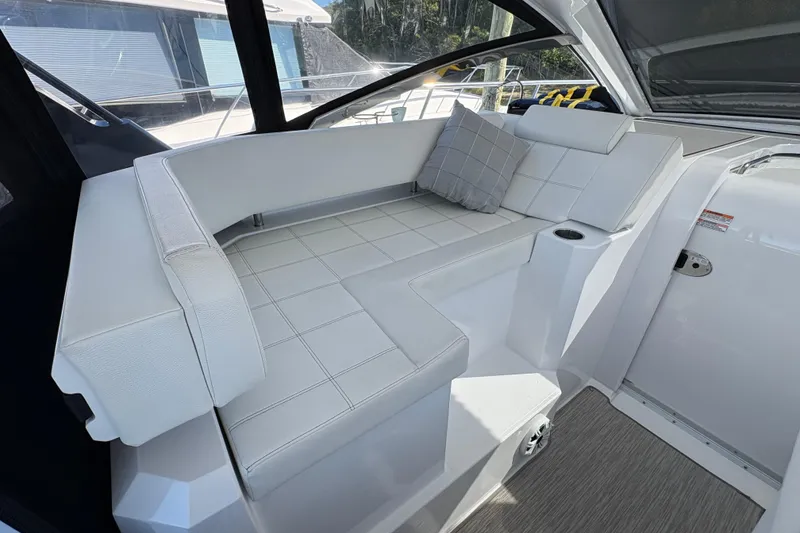 Slide: The Image of 2021 Cruisers Yachts 390 Express Coupe interior with white seating and cushion. - 4