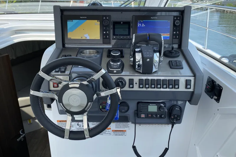 Slide: The Image of 2021 Cruisers Yachts 390 Express Coupe helm with advanced navigation and control systems. - 8