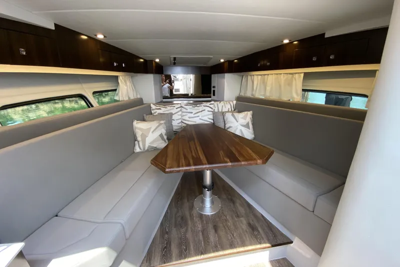 Slide: The Image of Luxurious interior of 2021 Cruisers Yachts 390 Express Coupe with elegant seating and wooden table. - 9
