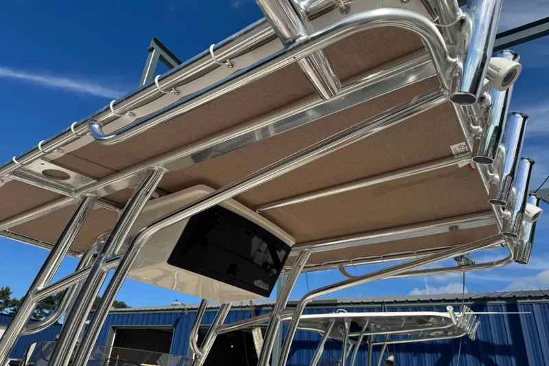 Slide: The Image of 2026 Pioneer 202 Islander boat with stainless steel T-top under blue sky. - 5