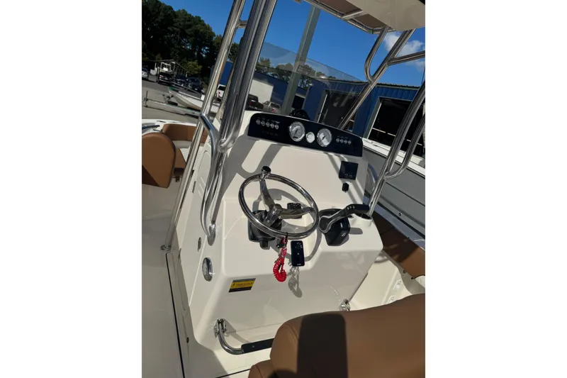 Slide: The Image of 2026 Pioneer 202 Islander boat console with steering wheel and gauges. - 6