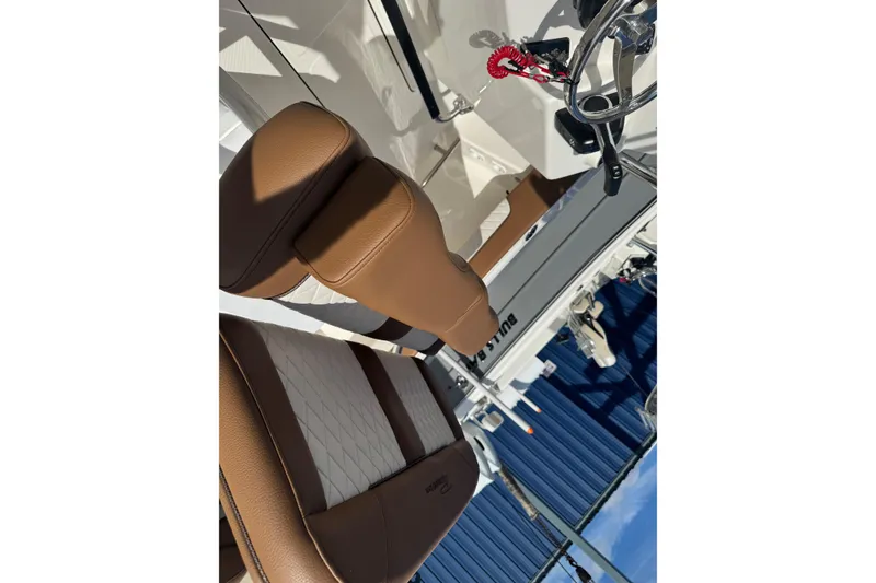 Slide: The Image of 2026 Pioneer 202 Islander boat interior with brown leather seats and steering wheel. - 7