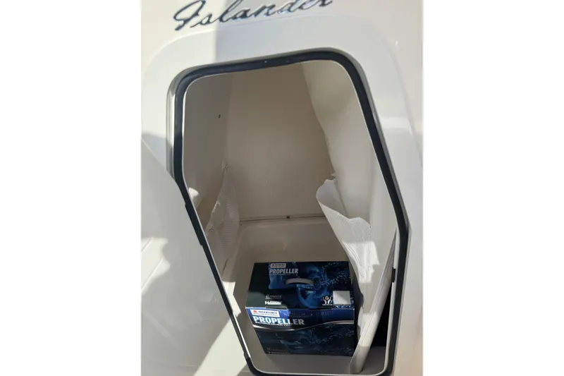 Slide: The Image of 2026 Pioneer 202 Islander storage compartment with a Suzuki propeller box inside. - 8