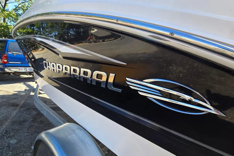 Slide: The Image of 2012 Chaparral 196 SSi boat side view with logo and sleek design. - 10